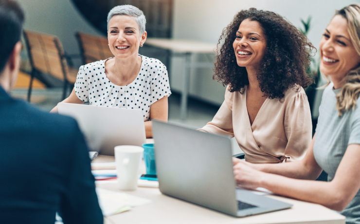 Business women sitting at a table having a business meeting.