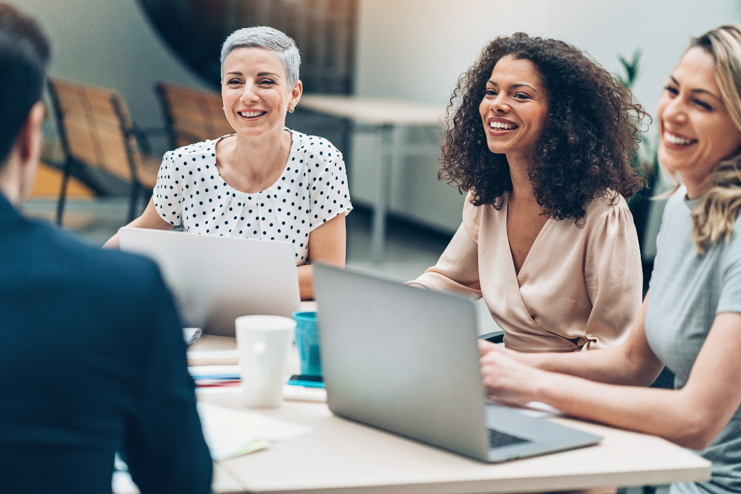 Business women sitting at a table having a business meeting.