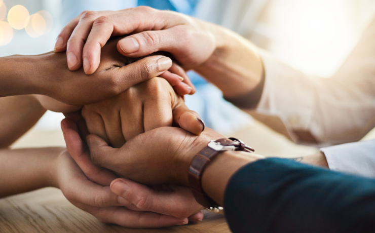 Hands stacked on top of each other in teamwork
