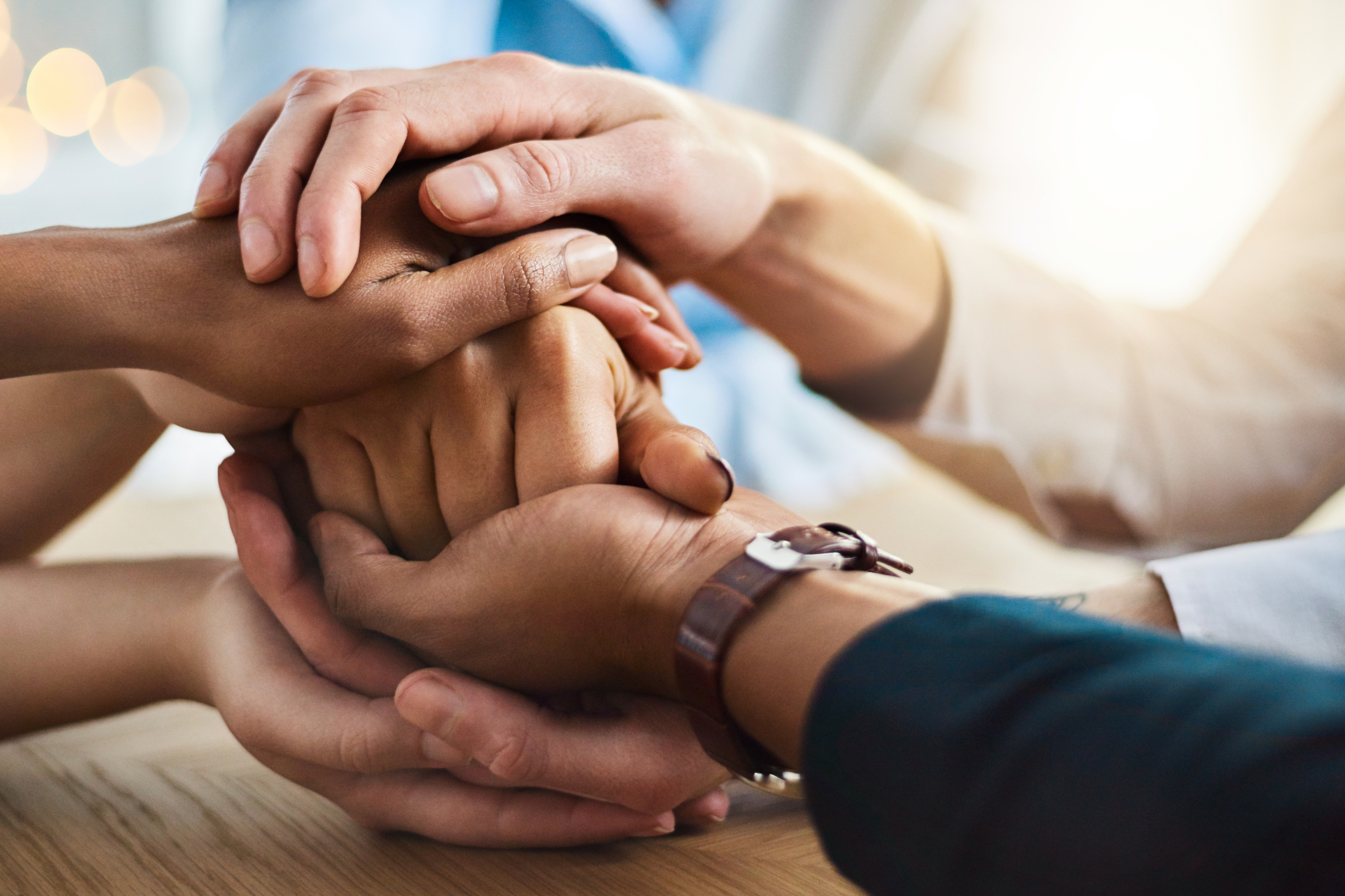 Hands stacked on top of each other in teamwork