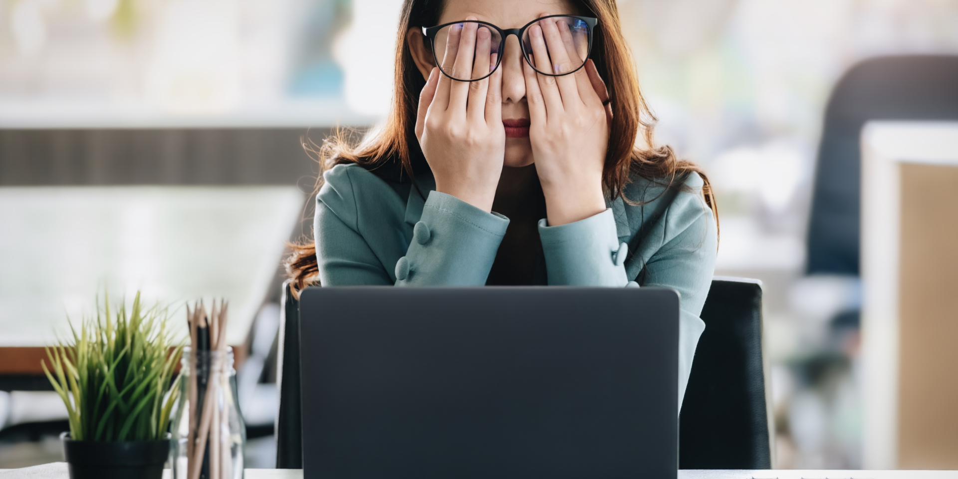 Woman holding her face because she is burntout