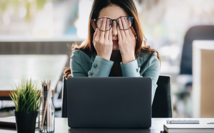 Woman holding her face because she is burntout