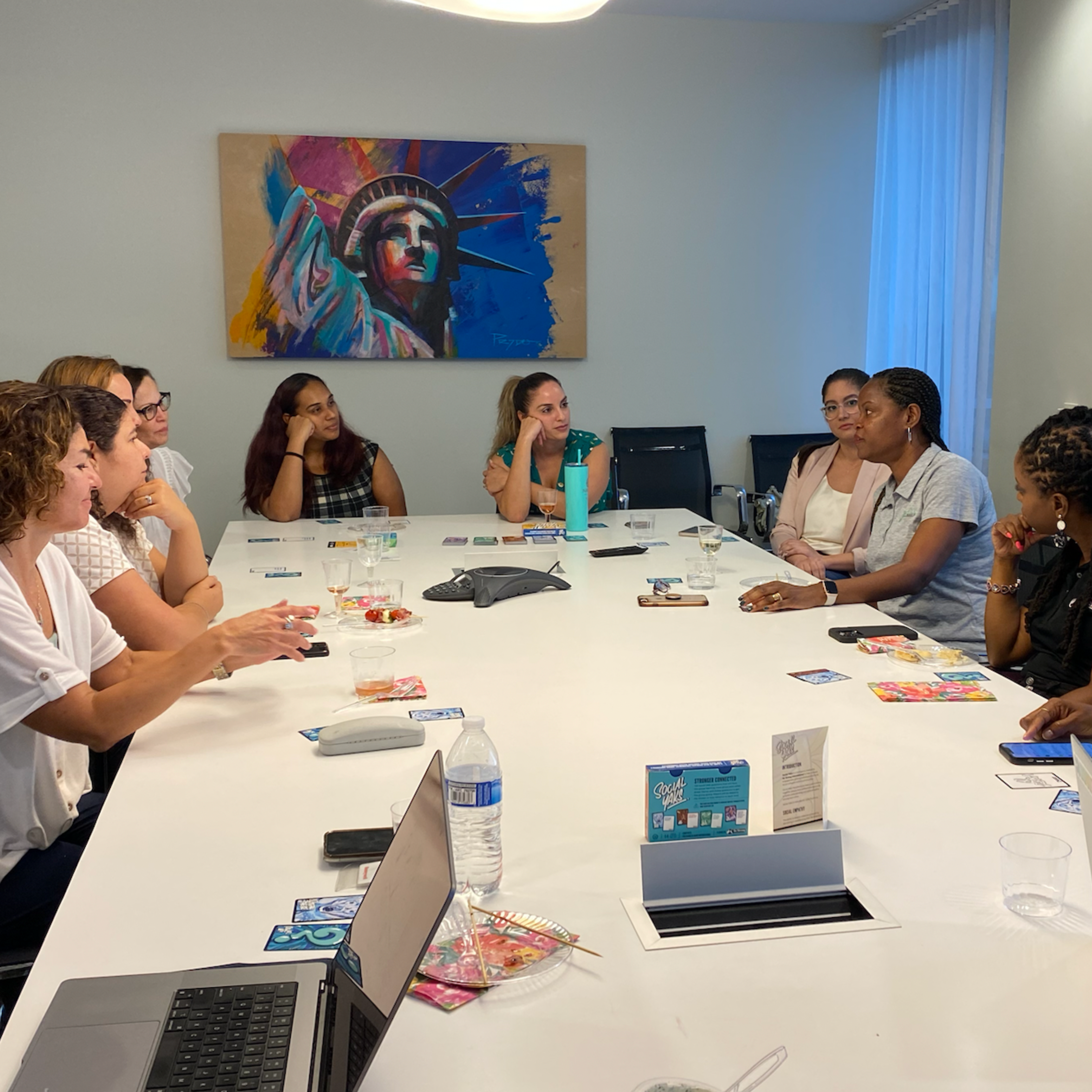 Meeting among Yanyn and colleagues in conference room.