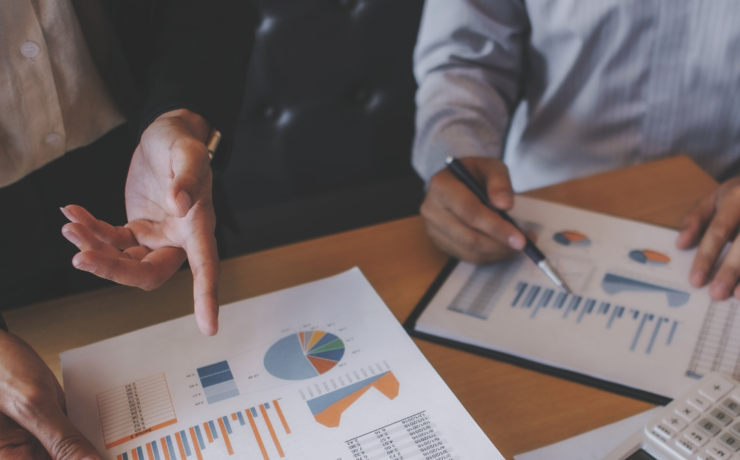 Diverse team reviewing ESG report to monitor progress
