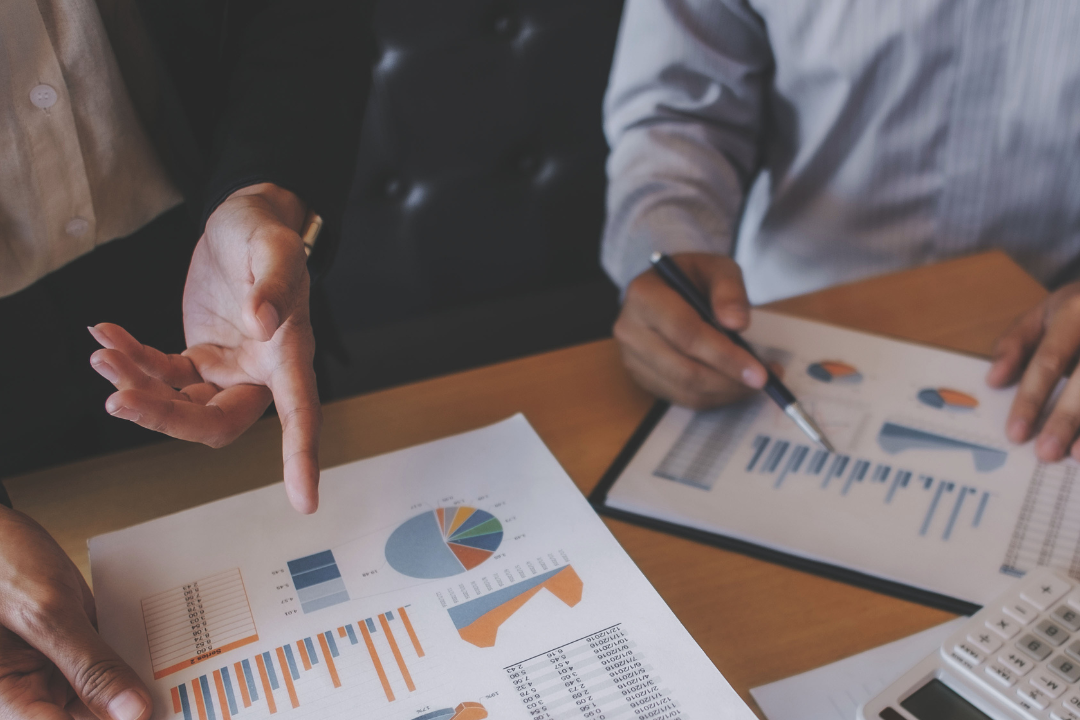 Diverse team reviewing ESG report to monitor progress